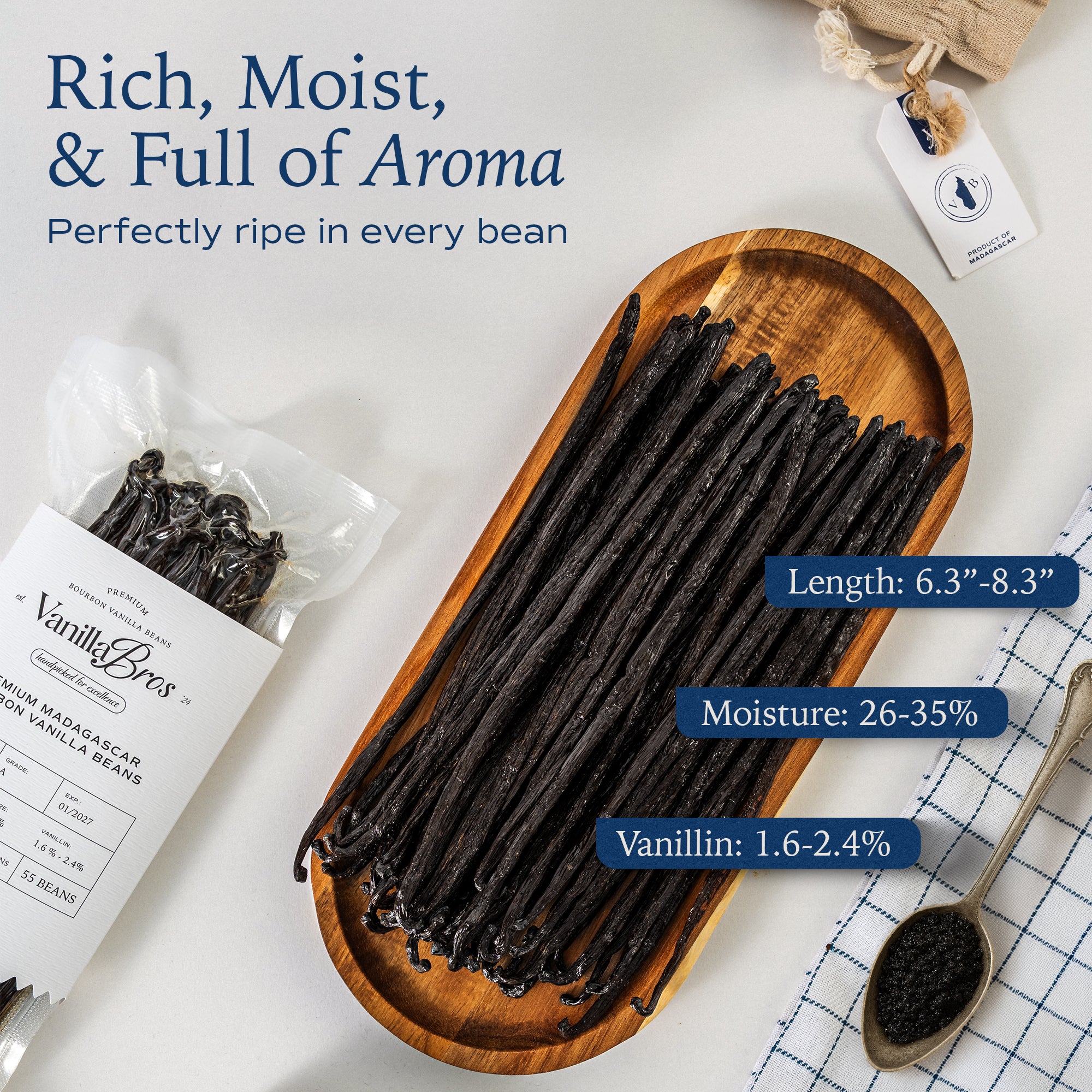 VanillaBros Premium Madagascar Bourbon vanilla beans on wooden tray showing grade A quality specs — 6.3–8.3 inch length, 26–35% moisture, 1.6–2.4% vanillin content