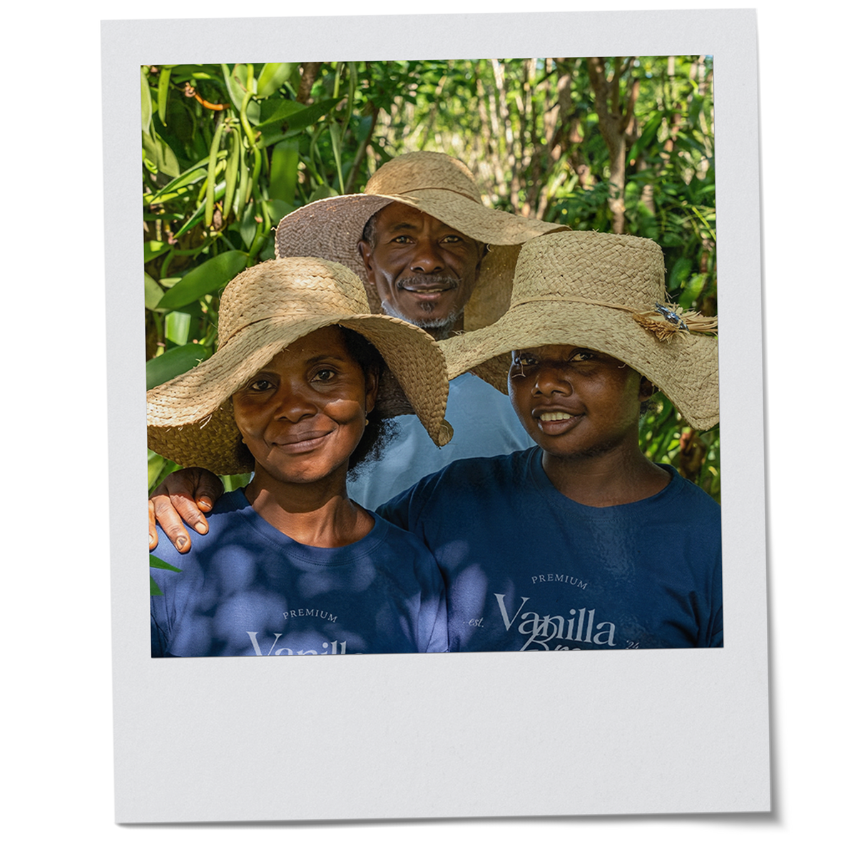 VanillaBros Madagascar vanilla farming family smiling in straw hats among vanilla plants on the plantation